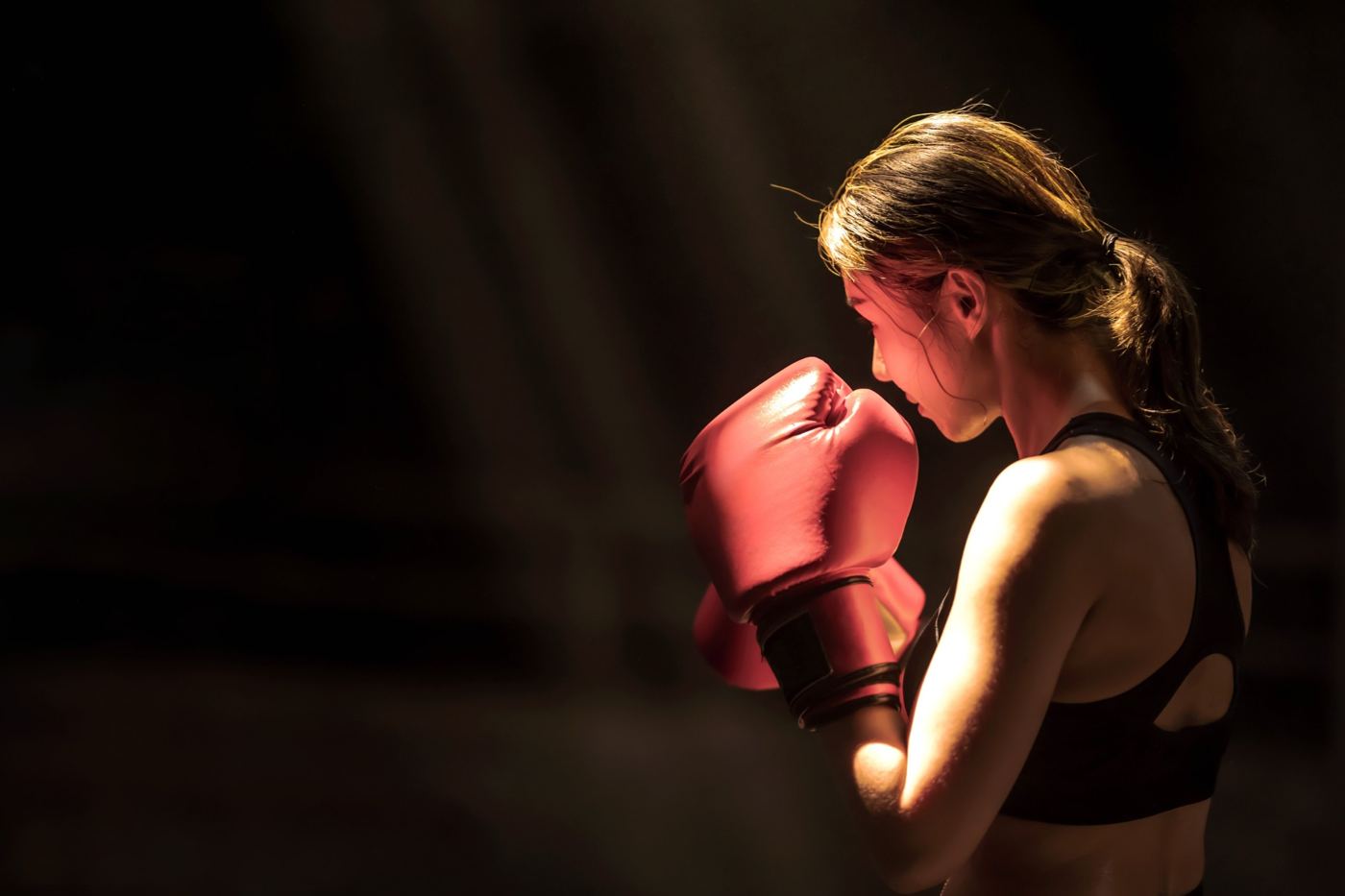 A woman in boxing gloves training